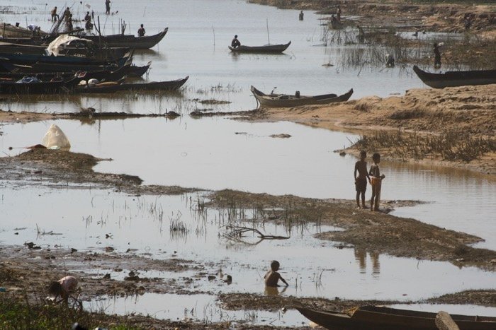 An image of African kids near a dry river